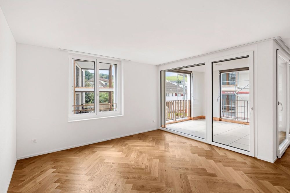 Hochmoderne 3.5-Zimmerwohnung mit Balkon im Erstbezug - Wohnzimmer
