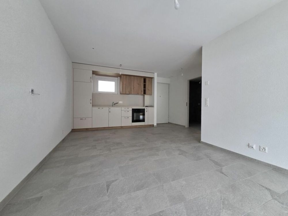 Neuf - Appartement de 2.5 pièces avec balcon et place de parc - Bild 1
