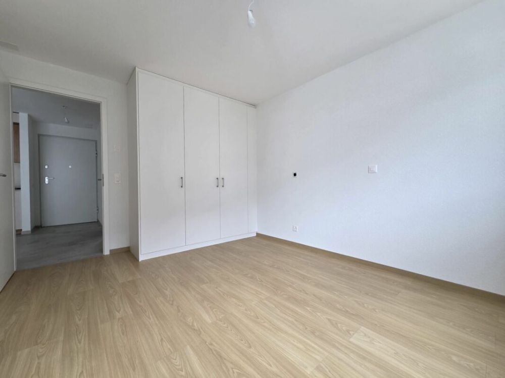 Neuf - Appartement de 2.5 pièces avec balcon et place de parc - Bild 4